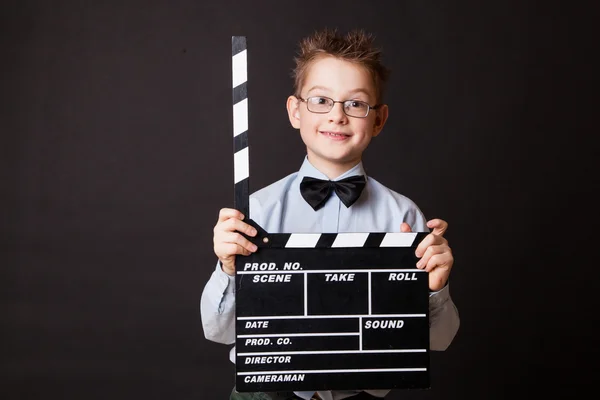 Little boy holding clapper board in hands. — Stock Photo, Image