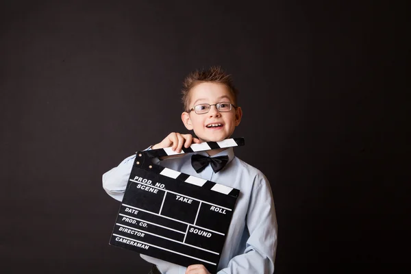 Little boy holding clapper board in hands. — Stock Photo, Image