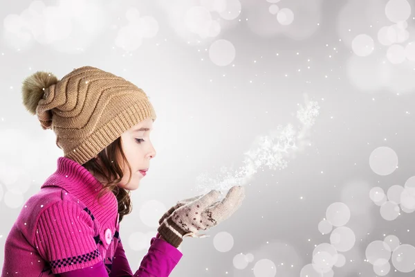 Happy beautiful little girl blowing snowflakes Royalty Free Stock Images