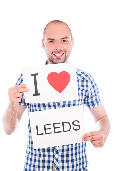 Man with city sign Leeds. — Stock Photo, Image