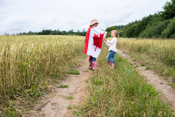 Two Little Smiling Girls Field Runs Canadian Flag — Stock Photo, Image