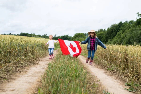 Two Little Smiling Girls Field Runs Canadian Flag — Stock Photo, Image