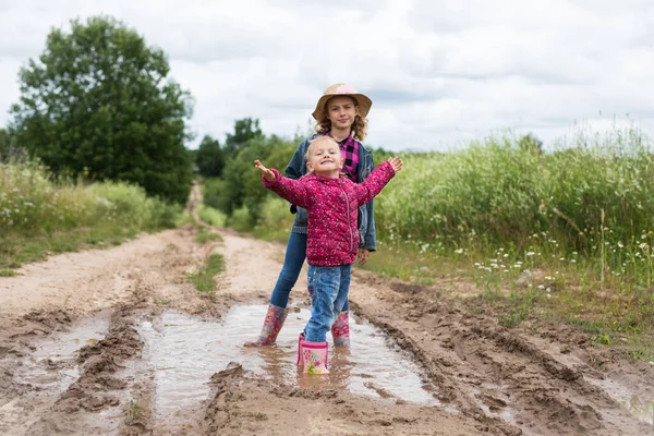 Two Smiling Girls Run Puddles Play — Photo