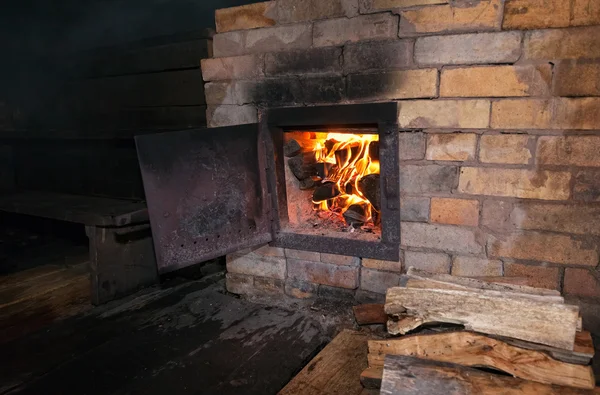 Old stove with open door and burning the wood — Stock Photo, Image