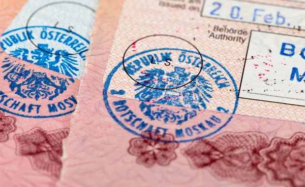 Visa entry and exit stamps in passport — Stock Photo, Image