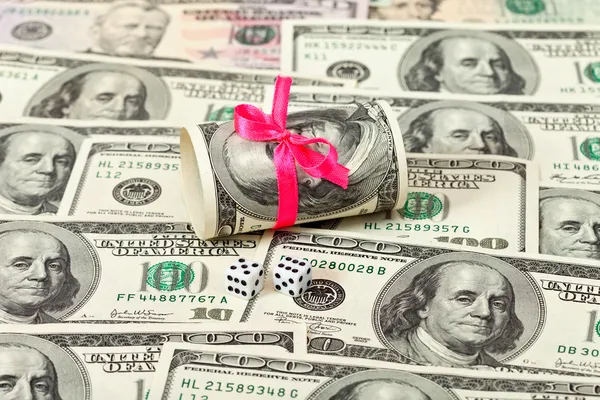 US dollars wrapped by ribbon on money background — Stock Photo, Image