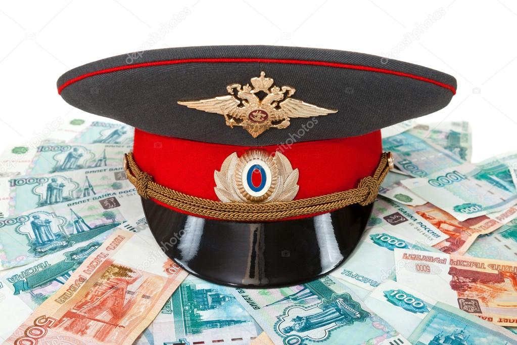 Russian police officer cap on the batch of banknotes