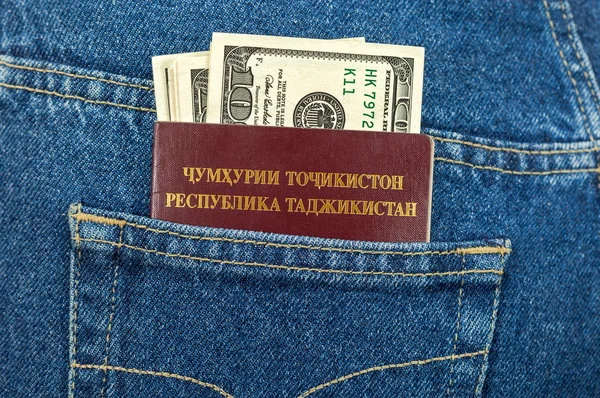 Tajikistan passport and dollar bills in the back jeans pocket — Stock Photo, Image