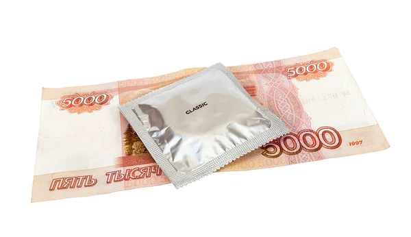 Condom with money on white background — Stock Photo, Image