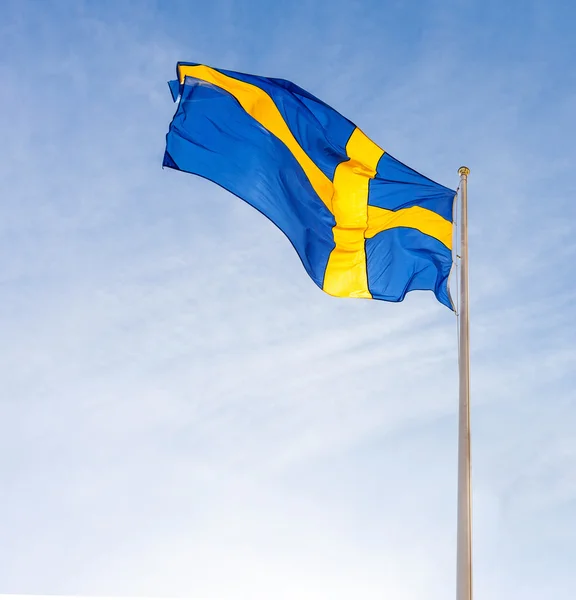 Flag of Sweden waving against blue sky — Stock Photo, Image