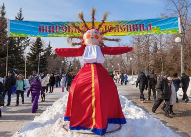 RUSSIA, SAMARA - March 2, 2014: Shrovetide in Russia. Big doll f clipart