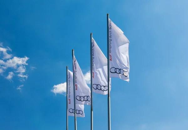 The flags of Audi over blue sky — Stock Photo, Image