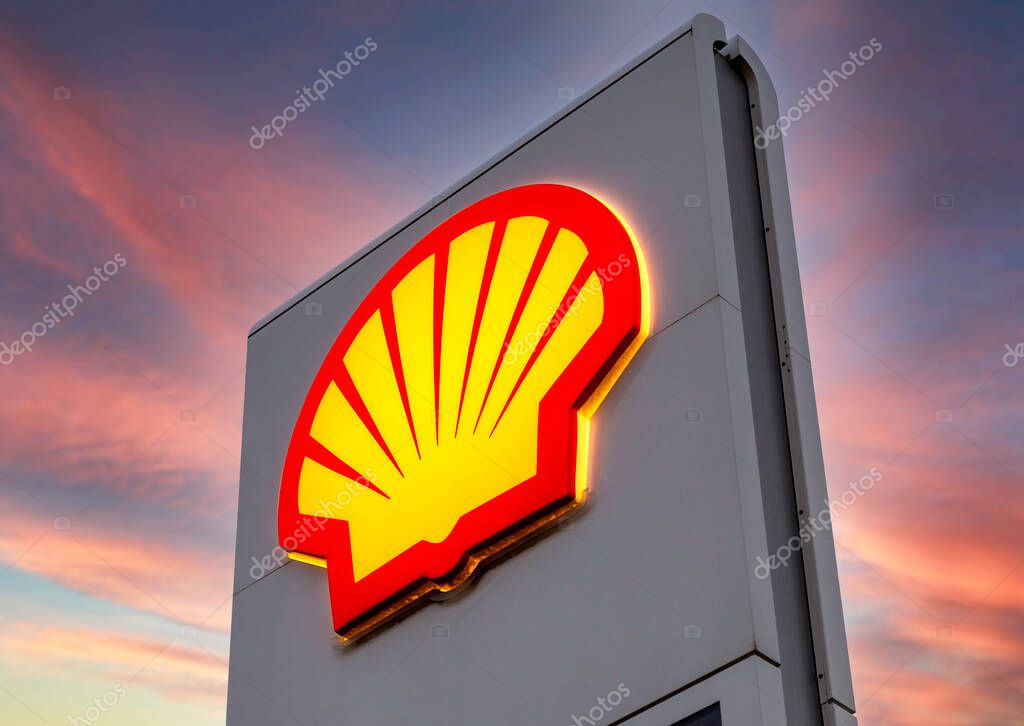 Moscow, Russia - July 5, 2021: Glowing emblem of Shell gas station against the sky. Shell fuel station