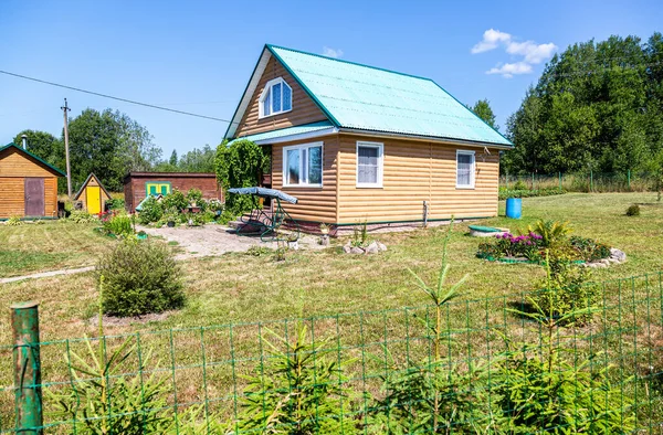 舒适的木制村舍 有外屋和美丽的装饰花 阳光明媚的夏日别墅 — 图库照片