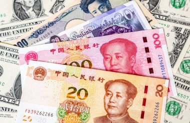 Various banknotes of Chinese and other currency on the dollars background. Business concept