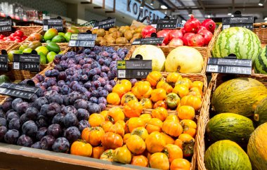 Samara, Russia - October 16, 2021: Fresh plum, persimmon, melons and other fruits sale in a chain superstore 