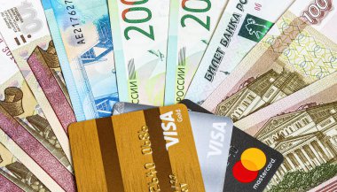 Moscow, Russia - January 4, 2021: MasterCard and Visa with russian rubles banknotes