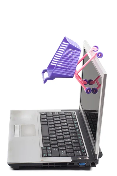 Laptop with a shopping-cart — Stock Photo, Image