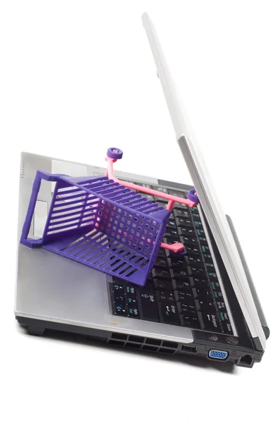 Laptop with a shopping-cart — Stock Photo, Image