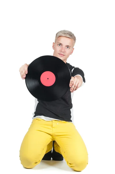 Young man showing from vinyl record — Stock Photo, Image