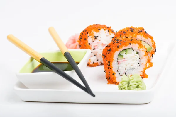 Chopsticks and sushi on the plate — Stock Photo, Image