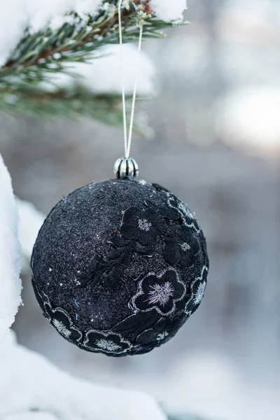 Siyah Parıltılı Noel Balosunu Ladin Üzerine Asmak Arka Planı Bulanıklaştırmak — Stok fotoğraf