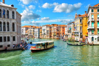 Scenic view of the Grand Canal, floating boats and gondolas in the center of Venice on a sunny day                               