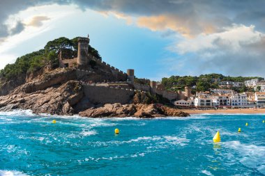 Picturesque view of the Mediterranean Sea, Gran Tossa Beach and Muralles de Tossa de Mar within the city of Tossa de Mar in sunny day. Catalonia, Girona, Costa Brava, Spain.