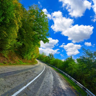 Old road on a steep slope in the Crimean mountains against the blue sky on a summer day. Crimea, Ukraine