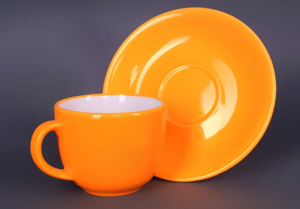 Orange Tasse und Untertasse — Stockfoto