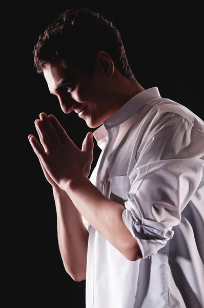 Low-key portrait of businessman praying for success — Stock Photo, Image