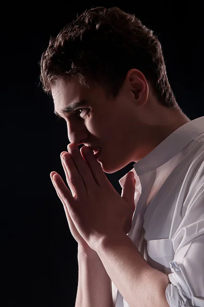 Low-key portrait of businessman praying for success — Stock Photo, Image