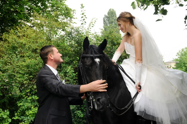 Wedding bride and groom on horseback — Stock Photo, Image