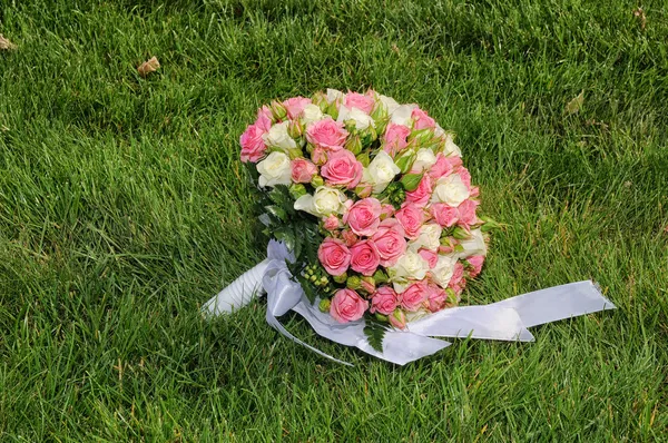 Bouquet de mariage de roses dans une herbe — Photo