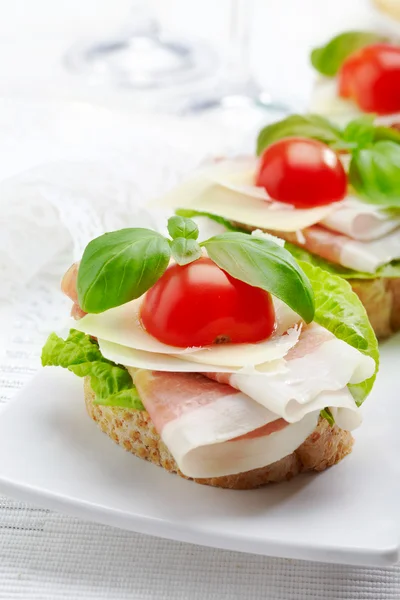 Sandwich with prosciutto, parmesan cheese and tomato — Stock Photo, Image