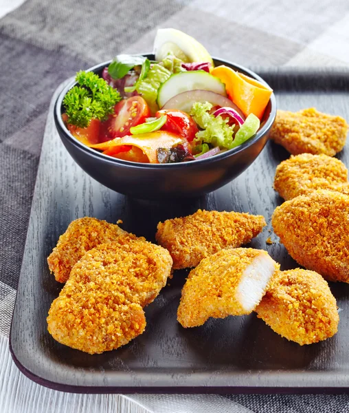 Chicken nuggets and fresh vegetable salad — Stock Photo, Image