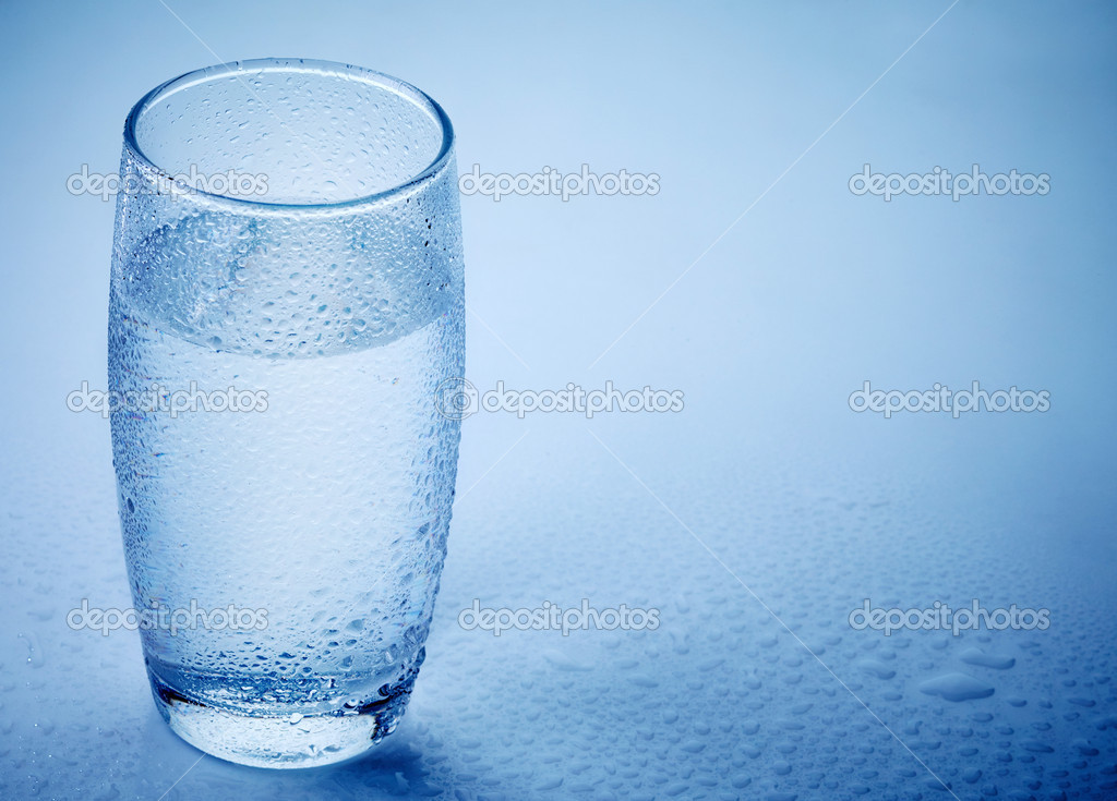 Wet glass of water on blue background Stock Photo by ©magone 30763011