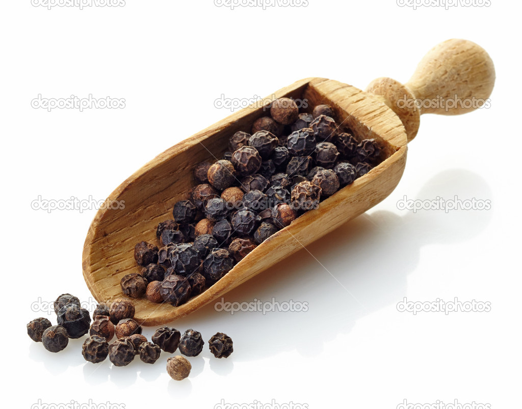 wooden scoop with black peppers