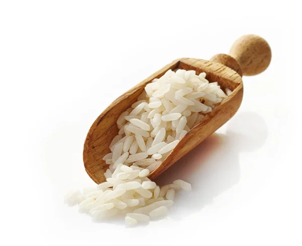 Wooden scoop with white rice — Stock Photo, Image