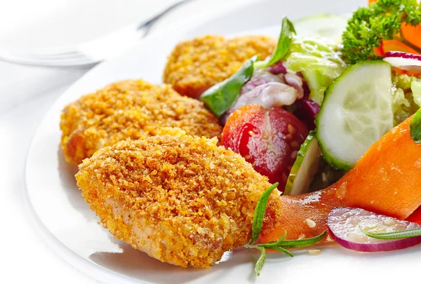 Chicken nuggets and vegetable salad — Stock Photo, Image