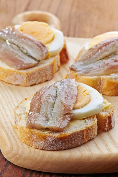 Bread with egg and anchovies — Stock Photo, Image