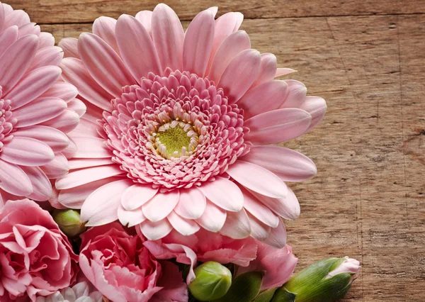 Pink flowers closeup on a wood background — Stock Photo, Image