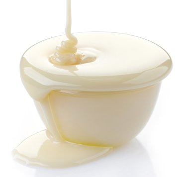 pouring condensed milk with sugar in a bowl clipart
