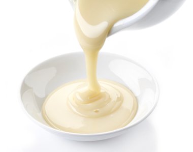 pouring condensed milk with sugar in a bowl clipart