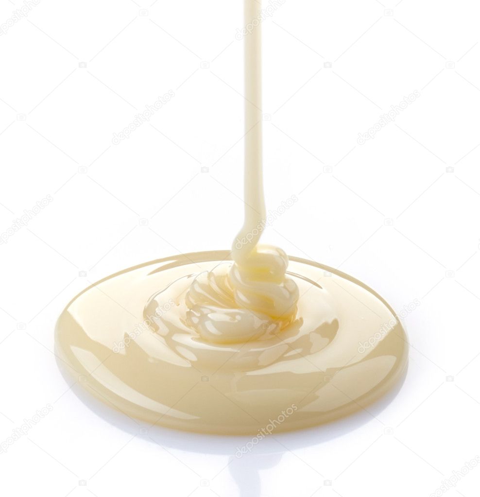 pouring condensed milk on a white background