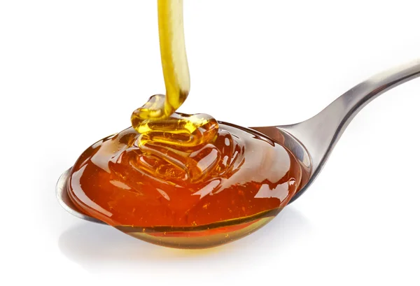 Pouring honey — Stock Photo, Image