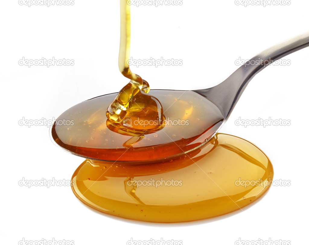 honey pouring into spoon