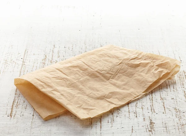 Brown wrapping paper on wooden table — Stock Photo, Image