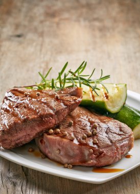 grilled beef steak on white plate clipart