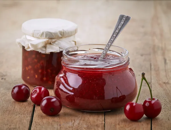 Two jars of fruit jam with cherries — Stock Photo, Image